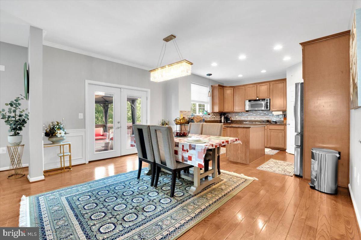 Chandelier, Dining room, Interior, Kitchen, Pendant Lights, Recessed Lighting, Stainless Steel Appliances, Wood Texture Flooring