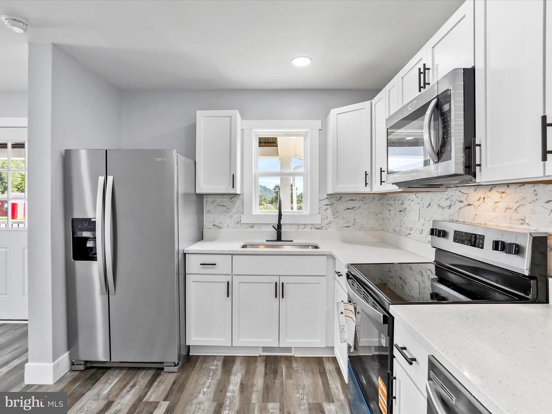 Interior, Kitchen, Marble Walls, Recessed Lighting, Stainless Steel Appliances, Wood Texture Flooring