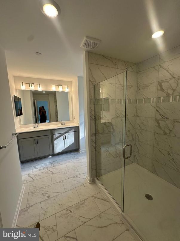 Bathroom, Dual Sink Vanities, Glass Shower, Interior, Marble, Marble Walls, Recessed Lighting