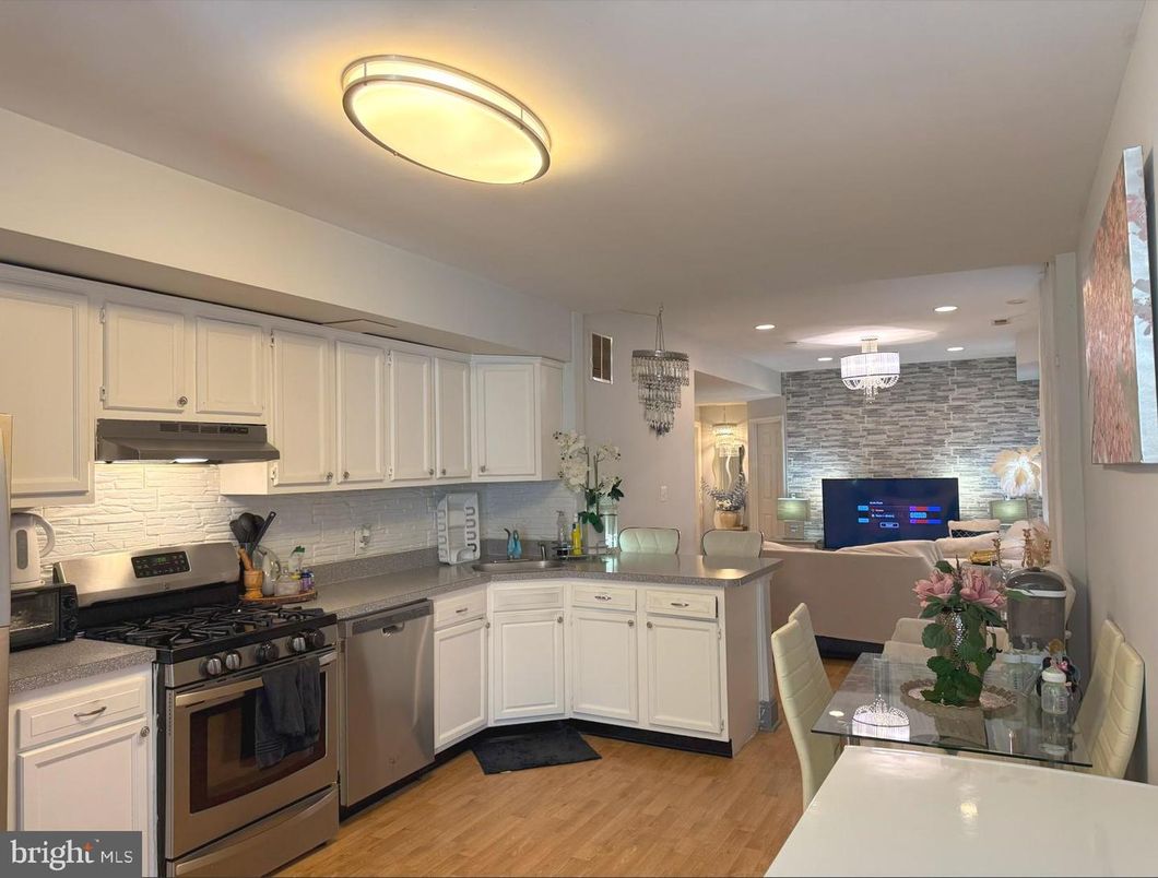 Dining room, Interior, Kitchen, Recessed Lighting, Stainless Steel Appliances, Stone Walls, Wood Texture Flooring