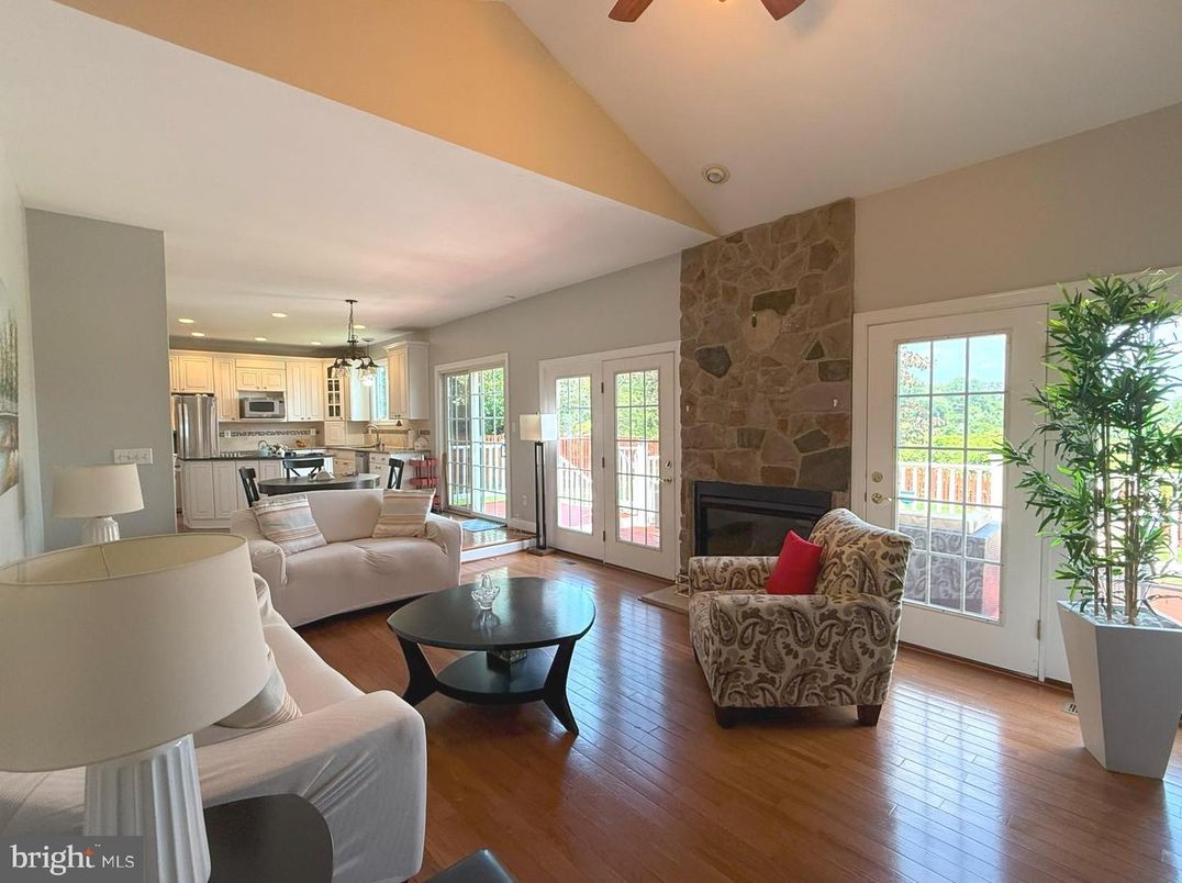 Fireplace, Interior, Kitchen, Living room, Pendant Lights, Recessed Lighting, Stainless Steel Appliances, Stone Walls, Wood Texture Flooring