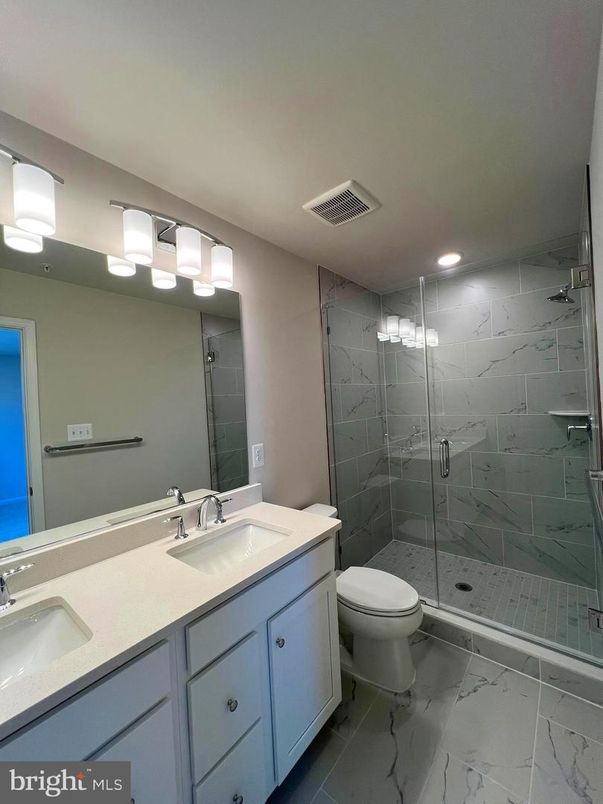 Bathroom, Dual Sink Vanities, Glass Shower, Interior, Marble, Marble Walls, Recessed Lighting