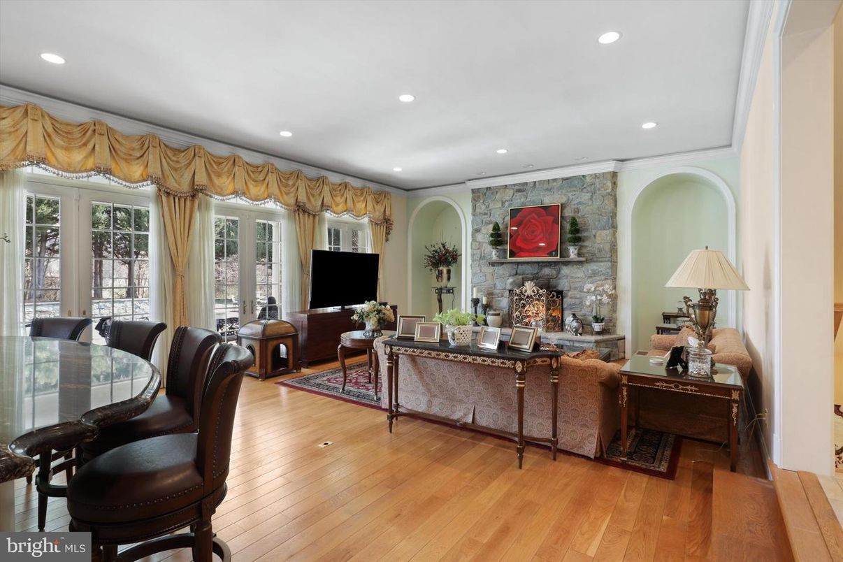 Dining room, Fireplace, Interior, Living room, Recessed Lighting, Stone Walls, Wood Texture Flooring