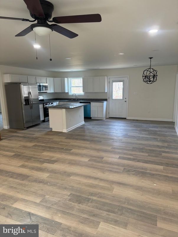 Empty room, Interior, Kitchen, Pendant Lights, Recessed Lighting, Stainless Steel Appliances, Wood Texture Flooring