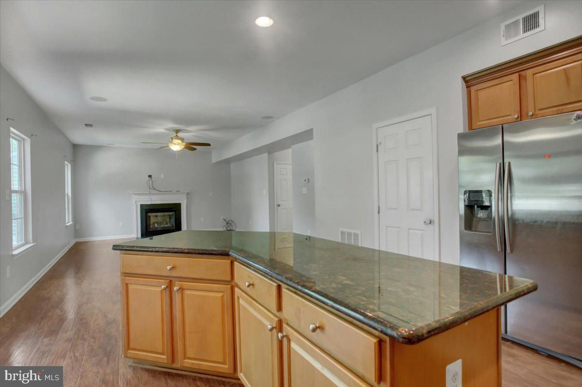 Fireplace, Interior, Kitchen, Recessed Lighting, Stainless Steel Appliances, Wood Texture Flooring