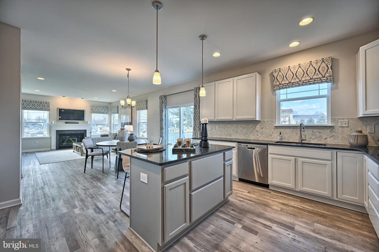 Chandelier, Dining room, Fireplace, Interior, Kitchen, Pendant Lights, Recessed Lighting, Stainless Steel Appliances, Wood Texture Flooring