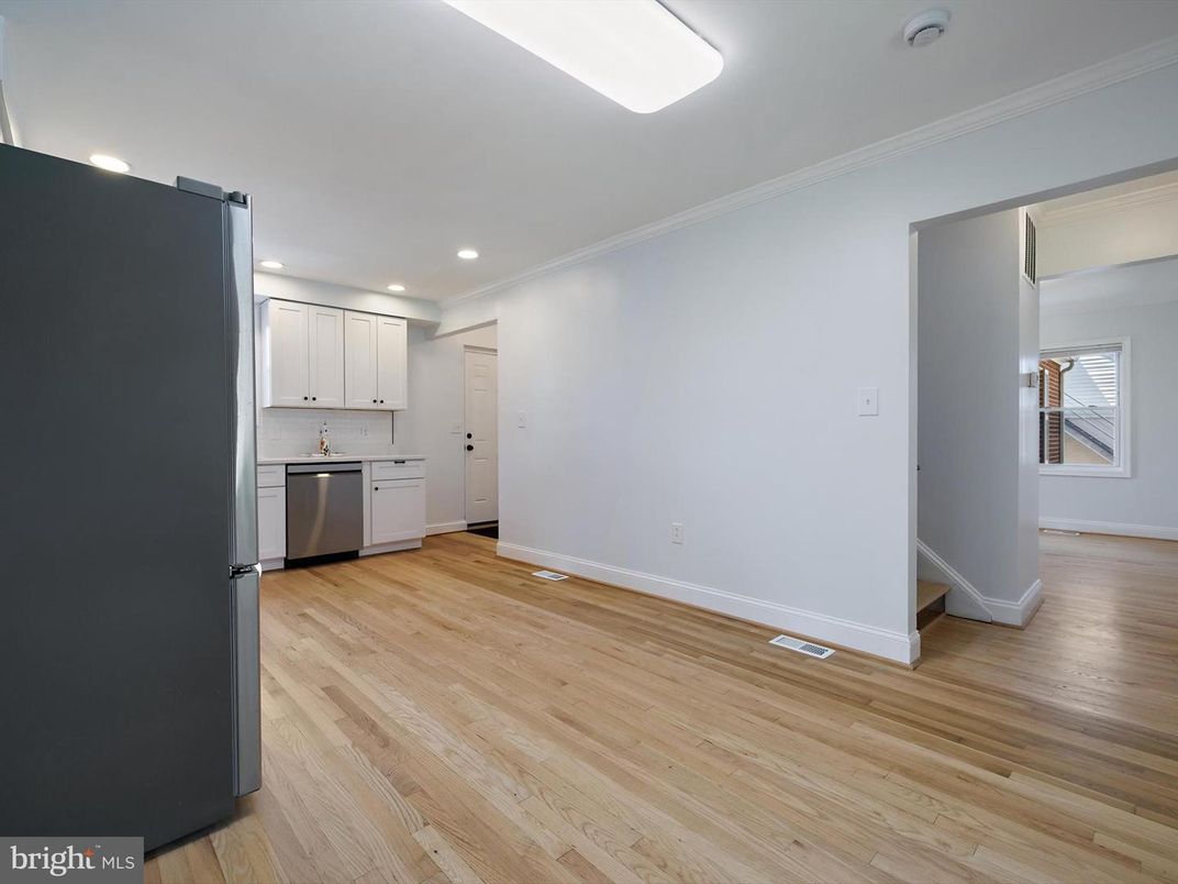 Empty room, Interior, Kitchen, Recessed Lighting, Stainless Steel Appliances, Wood Texture Flooring