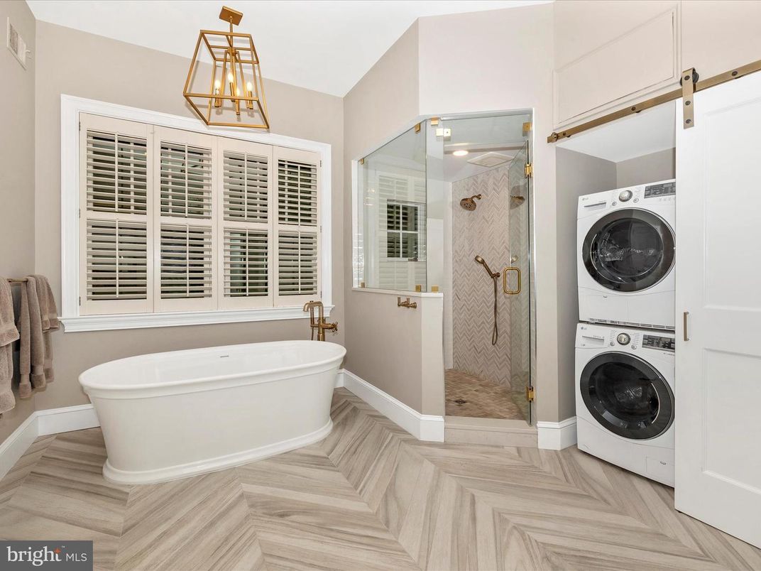Bathroom, Free Standing Baths, Glass Shower, Interior, Pendant Lights, Utility Closets, Washer, Wood Texture Flooring