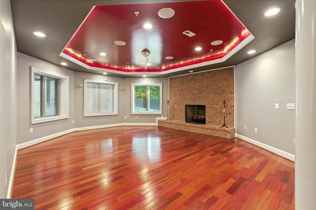 Empty room, Fireplace, Interior, Recessed Lighting, Stone Walls, Wood Texture Flooring