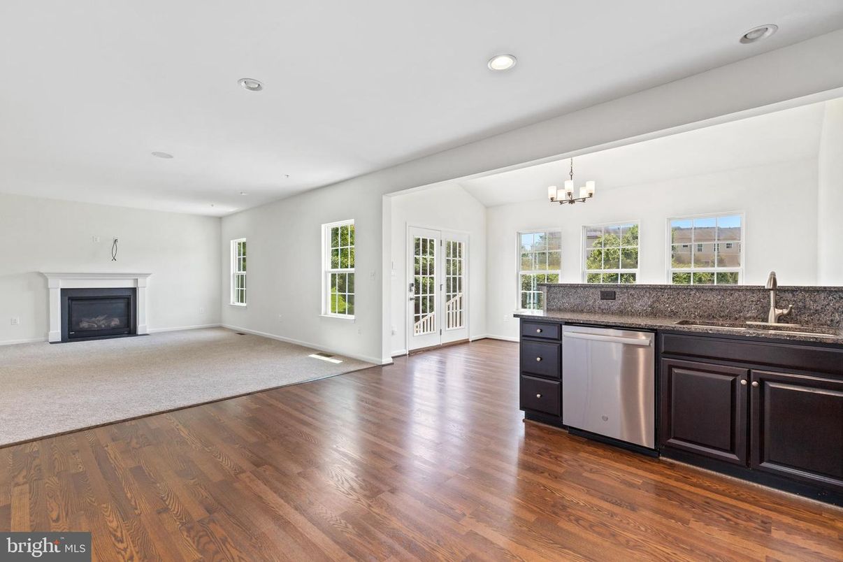 Chandelier, Empty room, Fireplace, Interior, Kitchen, Recessed Lighting, Wood Texture Flooring