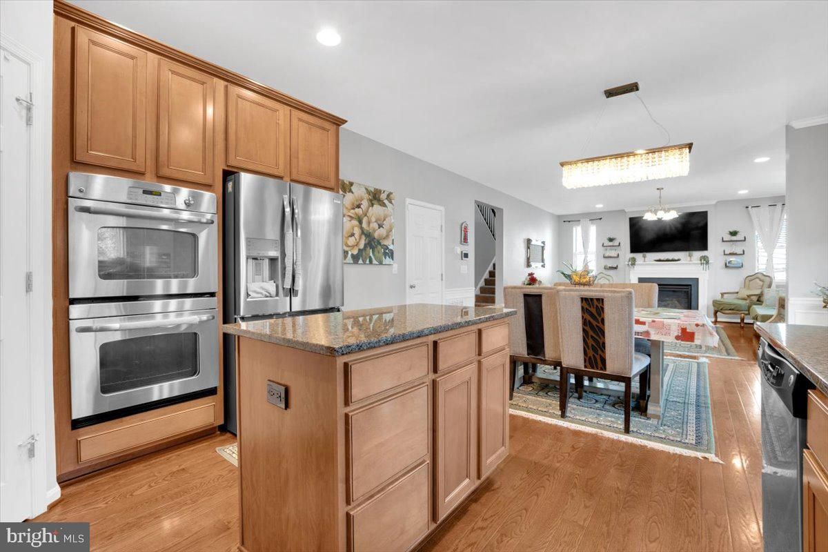 Chandelier, Dining room, Fireplace, Interior, Kitchen, Recessed Lighting, Stainless Steel Appliances, Wood Texture Flooring