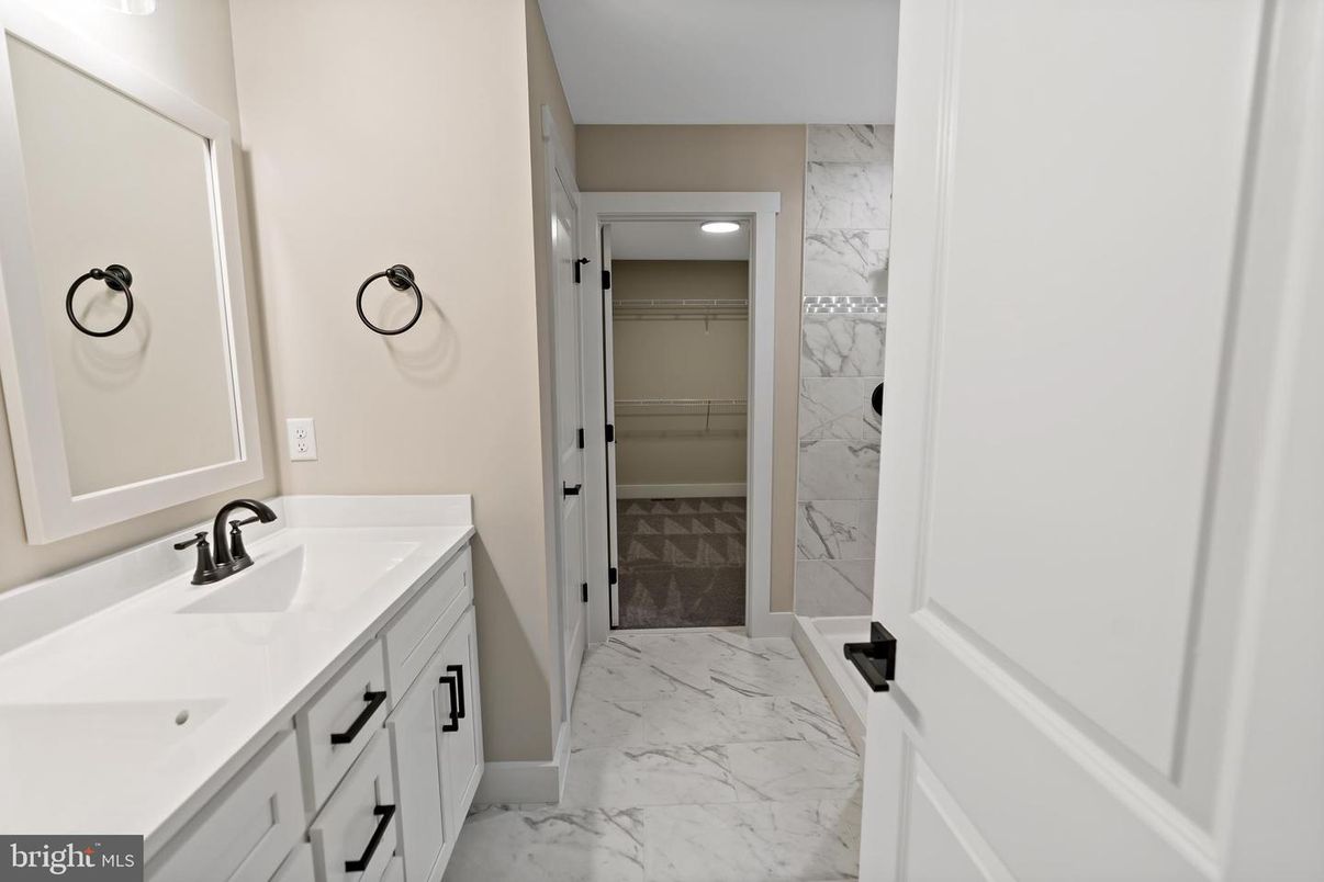 Bathroom, Dual Sink Vanities, Glass Shower, Interior, Marble, Marble Walls, Recessed Lighting