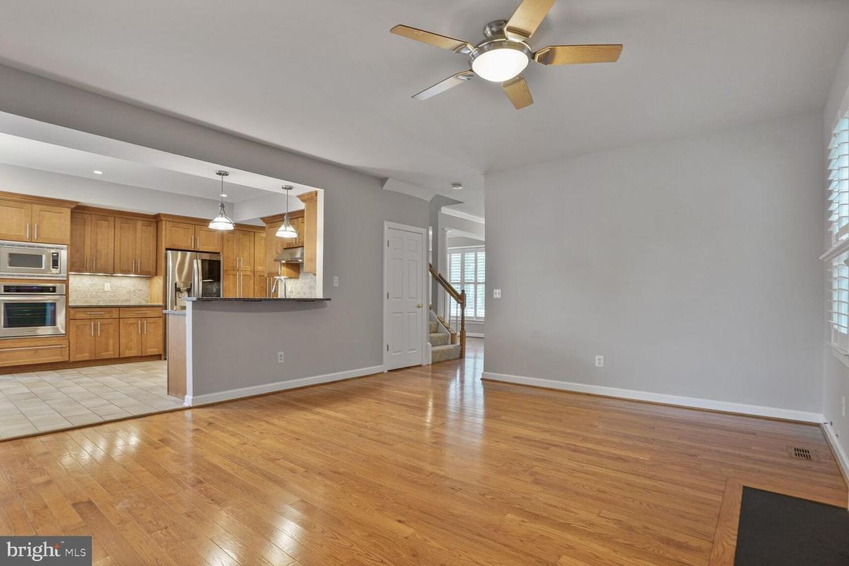 Empty room, Interior, Kitchen, Pendant Lights, Stainless Steel Appliances, Wood Texture Flooring