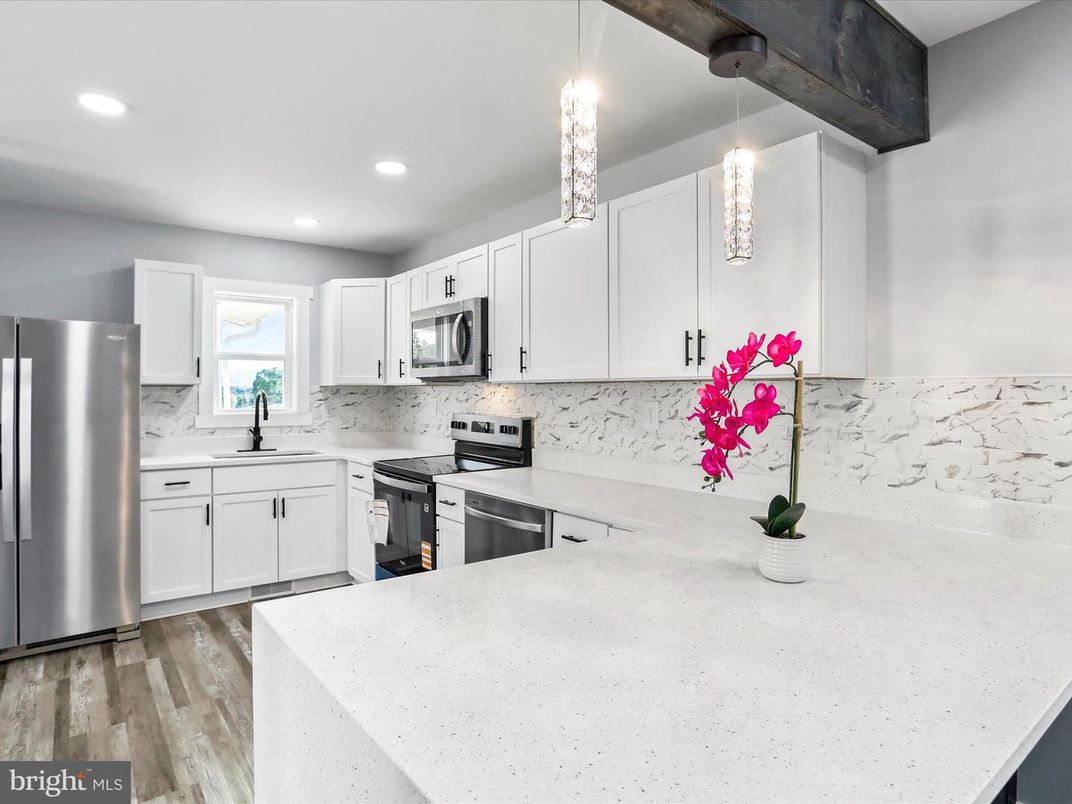 Interior, Kitchen, Marble Walls, Pendant Lights, Recessed Lighting, Stainless Steel Appliances, Wood Texture Flooring