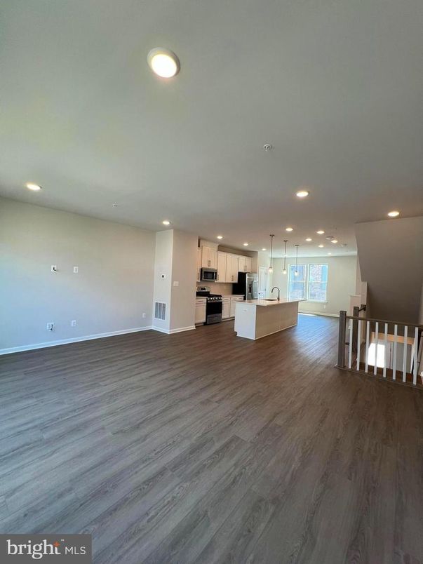 Empty room, Interior, Kitchen, Pendant Lights, Recessed Lighting, Stainless Steel Appliances, Wood Texture Flooring