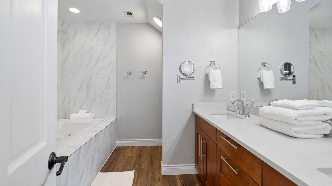 Bathroom, Dual Sink Vanities, Interior, Marble Walls, Recessed Lighting, Wood Texture Flooring
