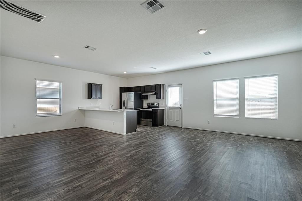 Empty room, Interior, Kitchen, Recessed Lighting, Stainless Steel Appliances, Wood Texture Flooring