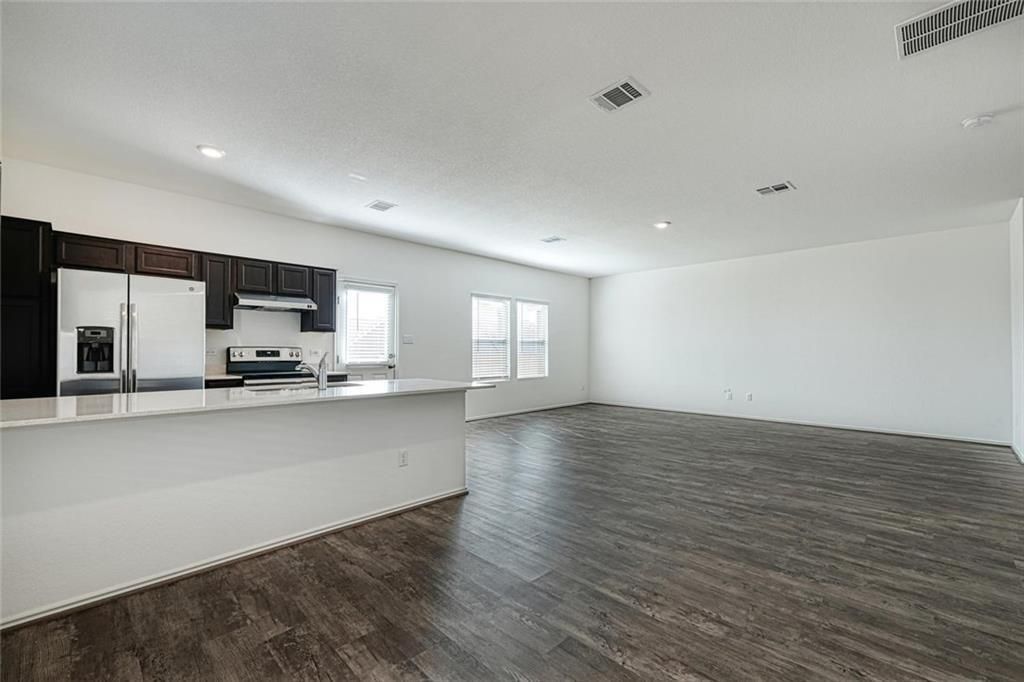 Empty room, Interior, Kitchen, Recessed Lighting, Stainless Steel Appliances, Wood Texture Flooring
