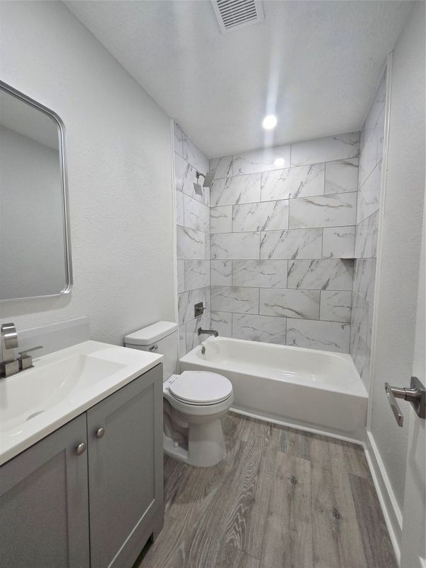 Bathroom, Dual Sink Vanities, Interior, Marble Walls, Recessed Lighting, Wood Texture Flooring