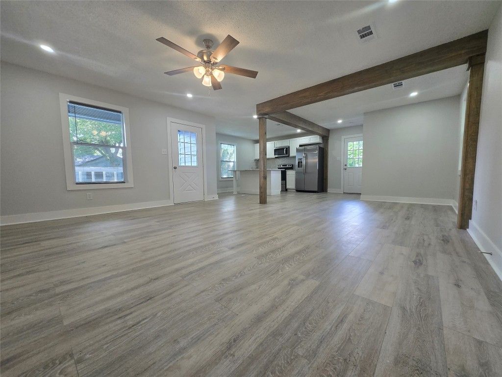 Empty room, Interior, Kitchen, Recessed Lighting, Stainless Steel Appliances, Wooden Beams, Wood Texture Flooring