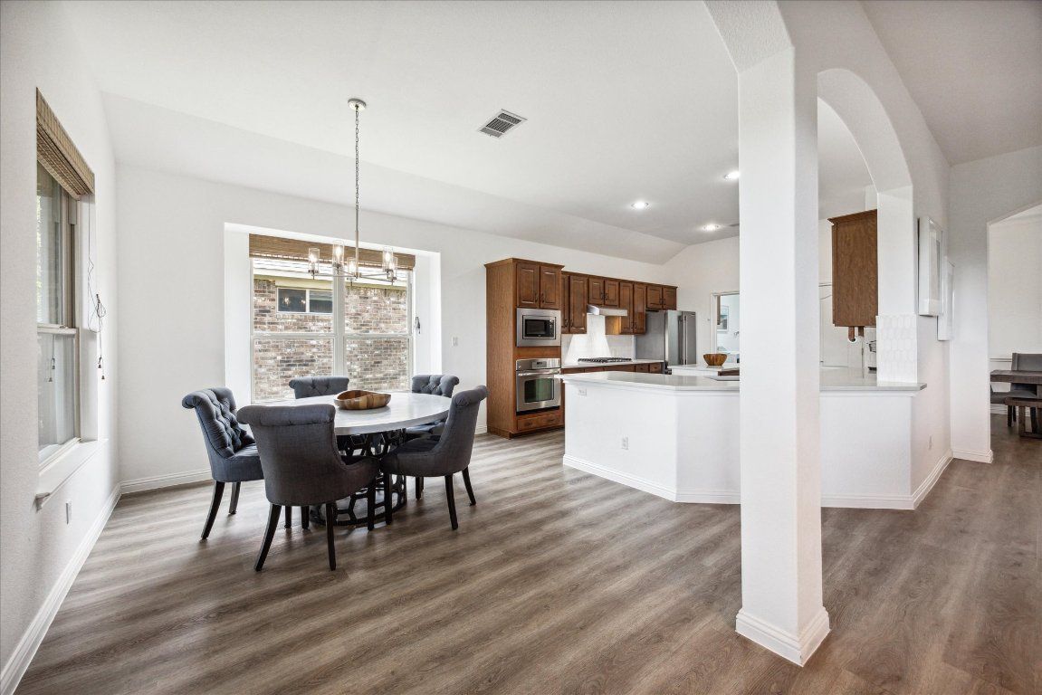 Chandelier, Dining room, Interior, Kitchen, Pendant Lights, Recessed Lighting, Stainless Steel Appliances, Wood Texture Flooring