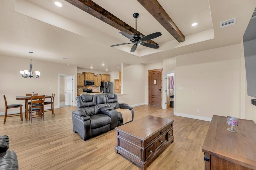 Chandelier, Dining room, Interior, Kitchen, Living room, Recessed Lighting, Stainless Steel Appliances, Wooden Beams, Wood Texture Flooring