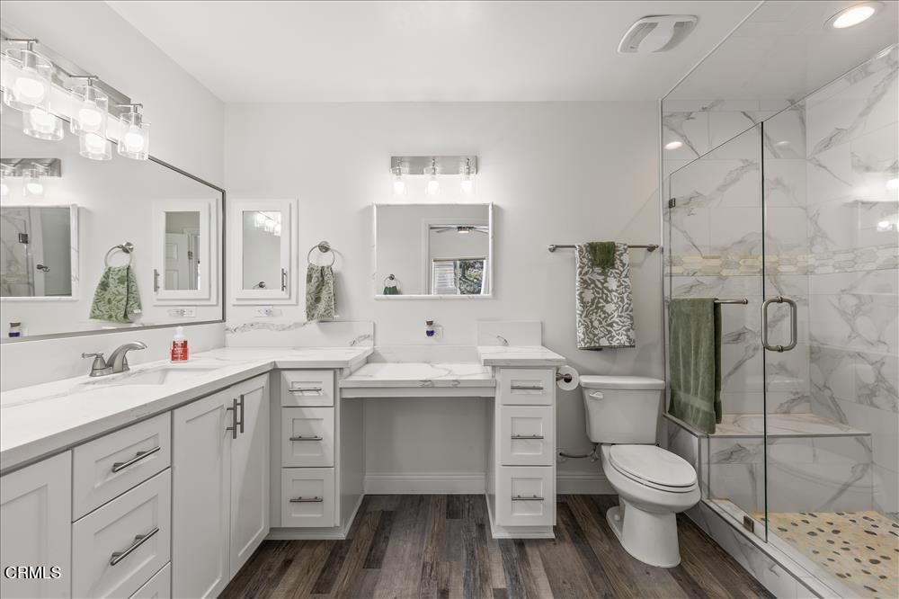 Bathroom, Dual Sink Vanities, Glass Shower, Interior, Marble Walls, Recessed Lighting, Wood Texture Flooring