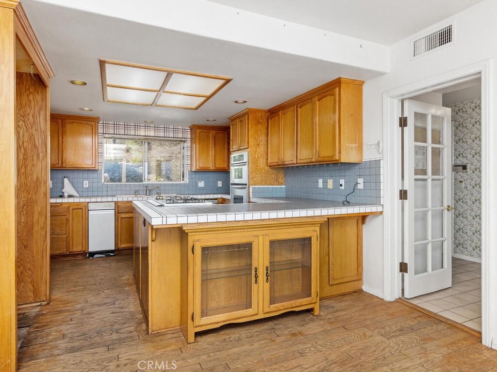 Interior, Kitchen, Recessed Lighting, Tile Countertops, Wood Texture Flooring