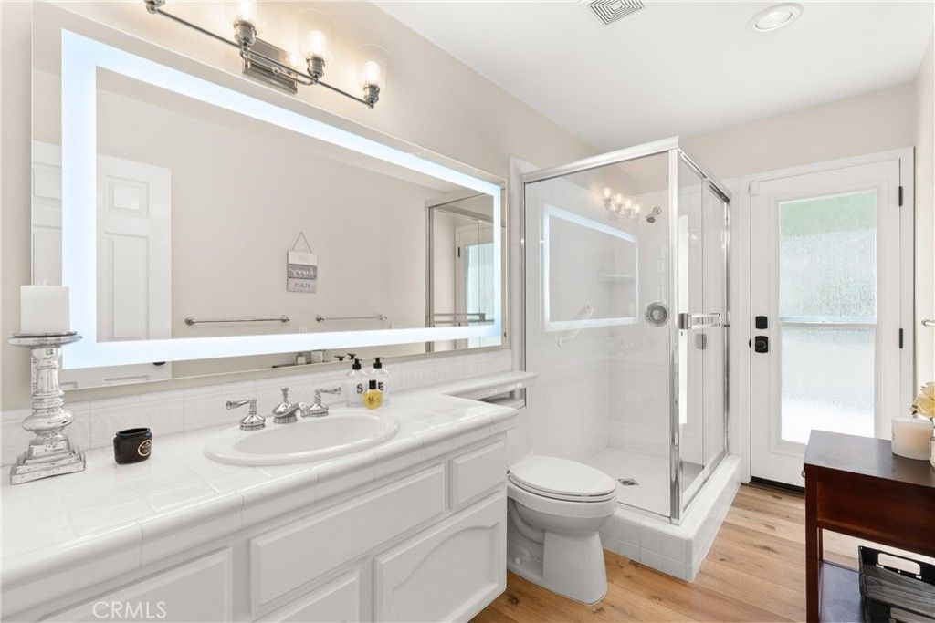 Bathroom, Glass Shower, Interior, Recessed Lighting, Tile Countertops, Wood Texture Flooring