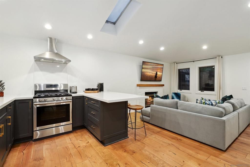 Fireplace, Interior, Kitchen, Living room, Recessed Lighting, Stainless Steel Appliances, Wood Texture Flooring