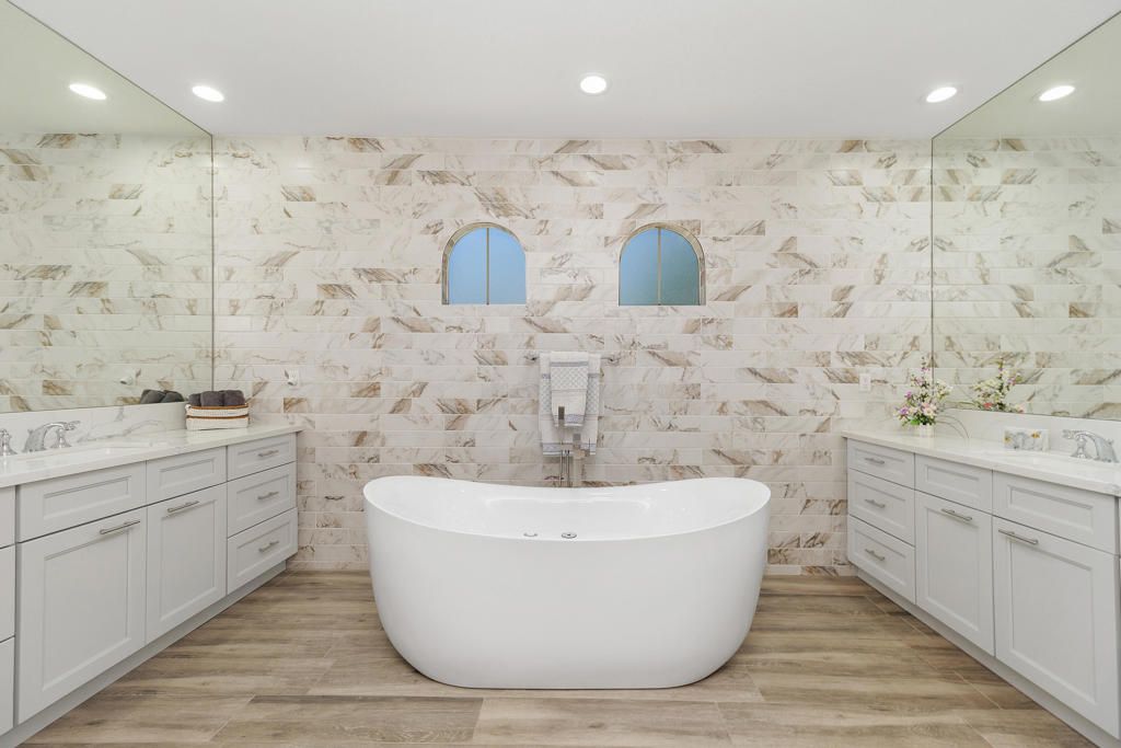 Bathroom, Dual Sink Vanities, Free Standing Baths, Glass Shower, Interior, Marble Walls, Recessed Lighting, Wood Texture Flooring