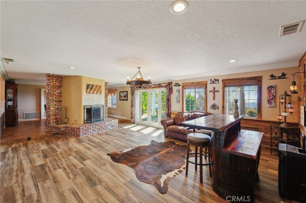 Dining room, Fireplace, Interior, Living room, Pendant Lights, Recessed Lighting, Wood Texture Flooring