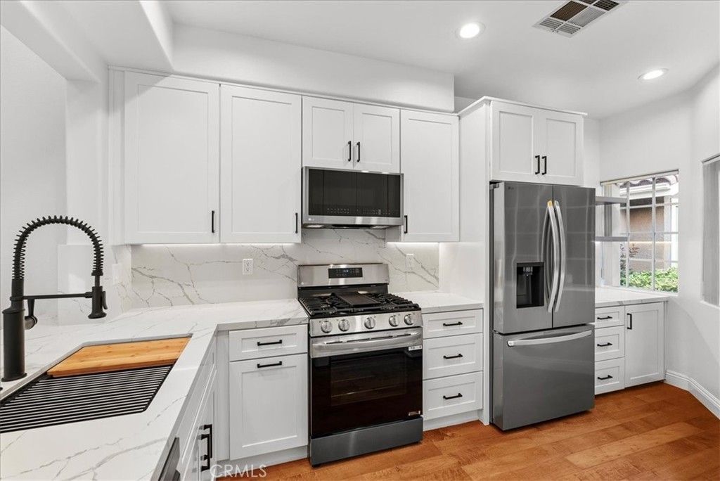Interior, Kitchen, Marble Walls, Recessed Lighting, Stainless Steel Appliances, Wood Texture Flooring