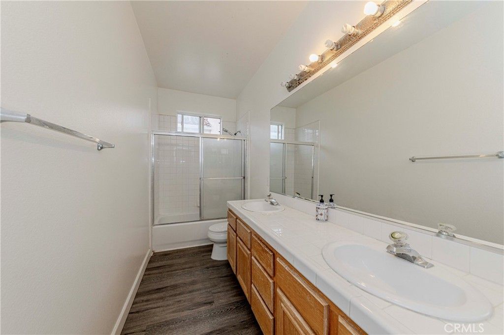 Bathroom, Dual Sink Vanities, Glass Shower, Interior, Tile Countertops, Wood Texture Flooring