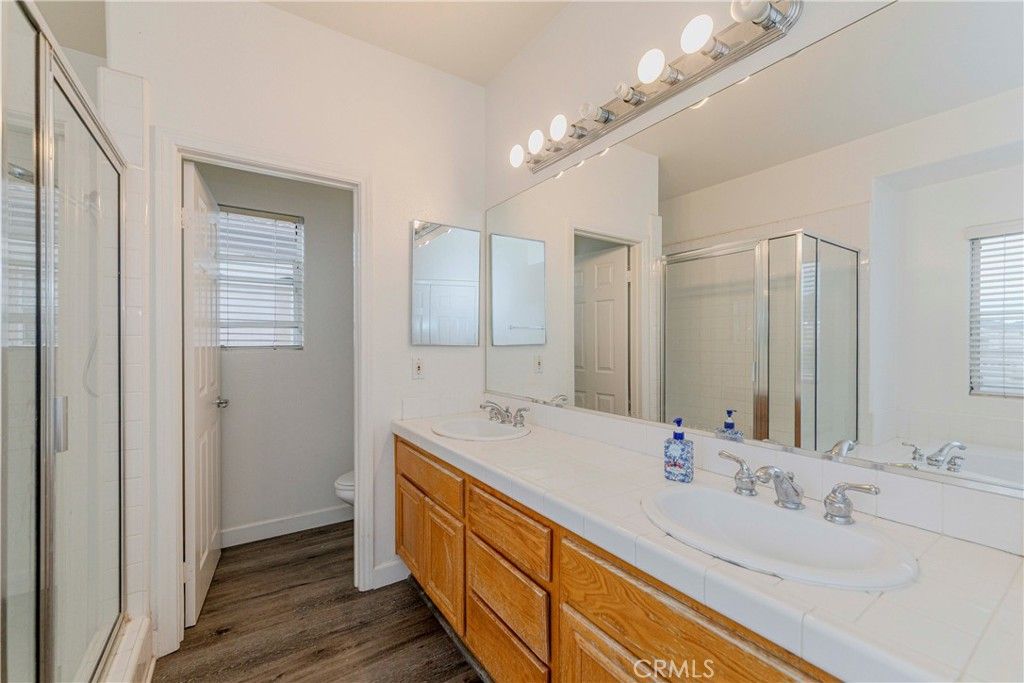Bathroom, Dual Sink Vanities, Glass Shower, Interior, Tile Countertops, Wood Texture Flooring