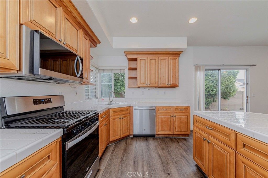 Interior, Kitchen, Recessed Lighting, Stainless Steel Appliances, Tile Countertops, Wood Texture Flooring