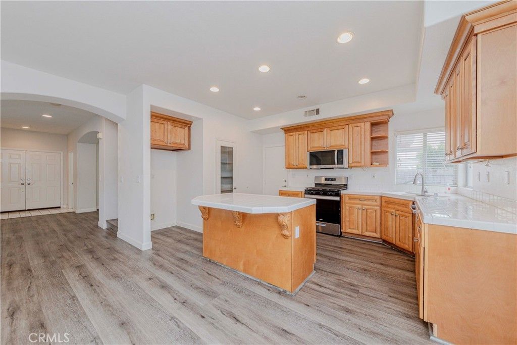 Interior, Kitchen, Recessed Lighting, Stainless Steel Appliances, Tile Countertops, Wood Texture Flooring