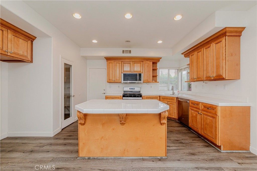 Interior, Kitchen, Recessed Lighting, Tile Countertops, Wood Texture Flooring
