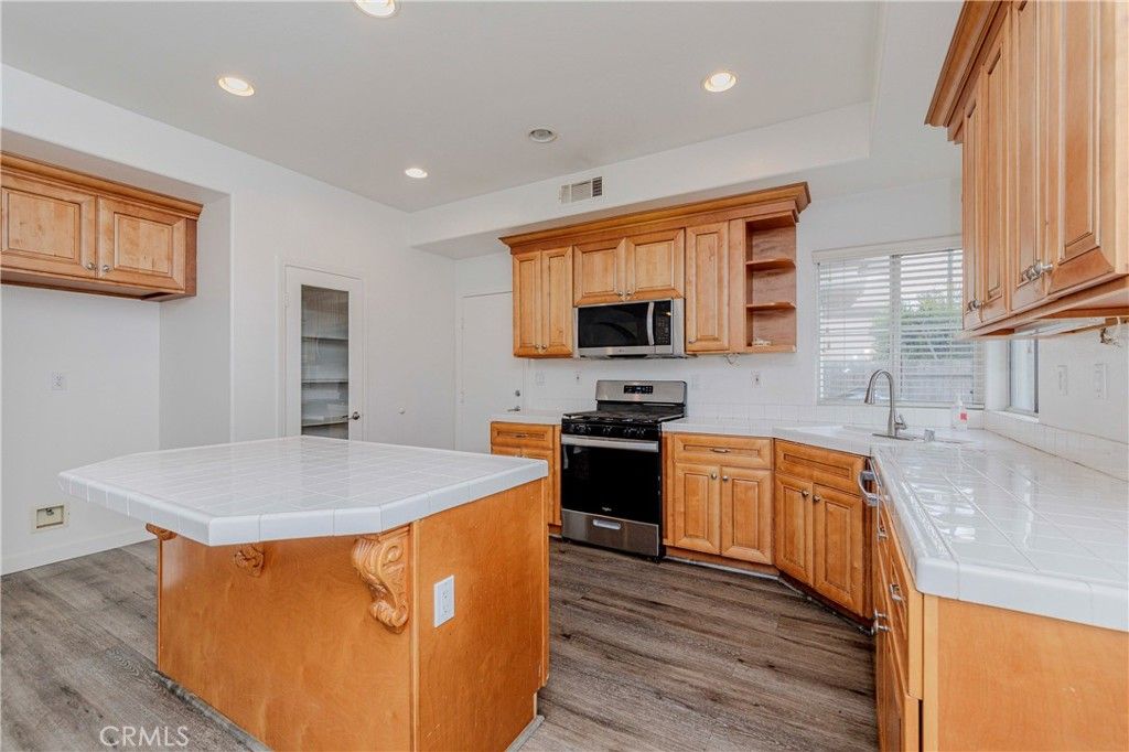 Interior, Kitchen, Recessed Lighting, Stainless Steel Appliances, Tile Countertops, Wood Texture Flooring