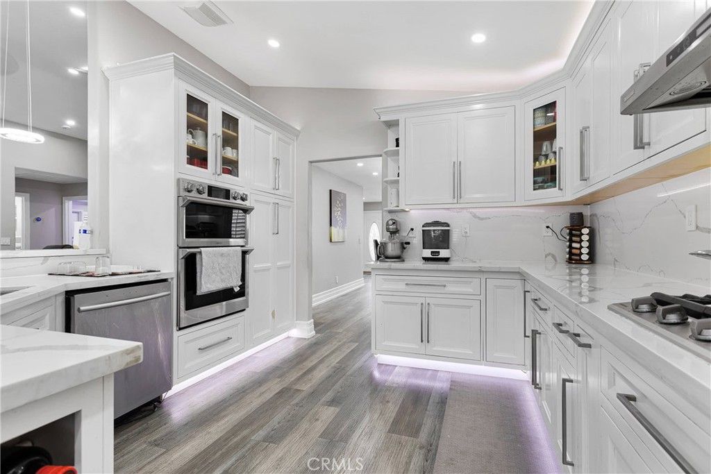 Interior, Kitchen, Marble Walls, Recessed Lighting, Stainless Steel Appliances, Wood Texture Flooring