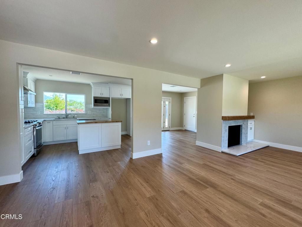 Empty room, Fireplace, Interior, Kitchen, Recessed Lighting, Wood Texture Flooring