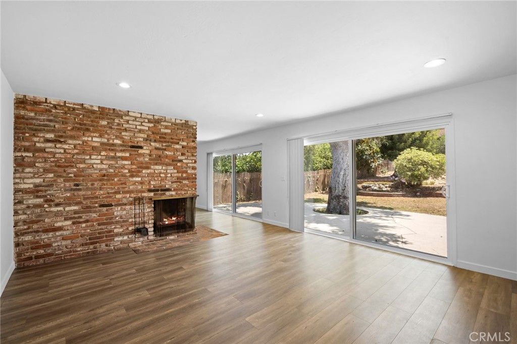 Empty room, Fireplace, Interior, Recessed Lighting, Stone Walls, Wood Texture Flooring