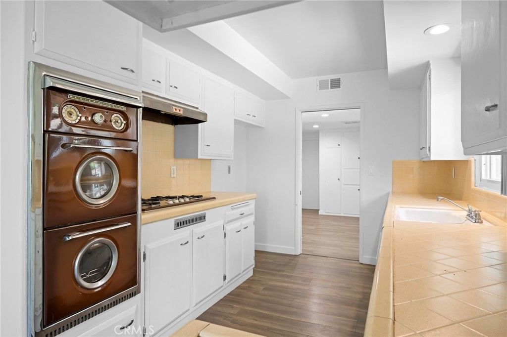 Interior, Kitchen, Recessed Lighting, Tile Countertops, Wood Texture Flooring