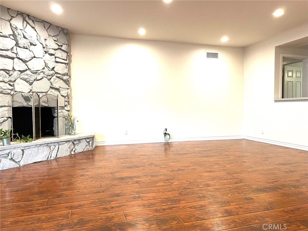 Empty room, Fireplace, Interior, Recessed Lighting, Stone Walls, Wood Texture Flooring