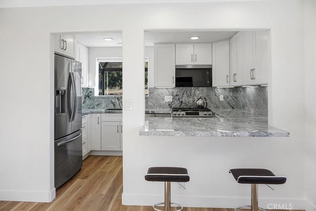 Interior, Kitchen, Marble Walls, Recessed Lighting, Stainless Steel Appliances, Wood Texture Flooring