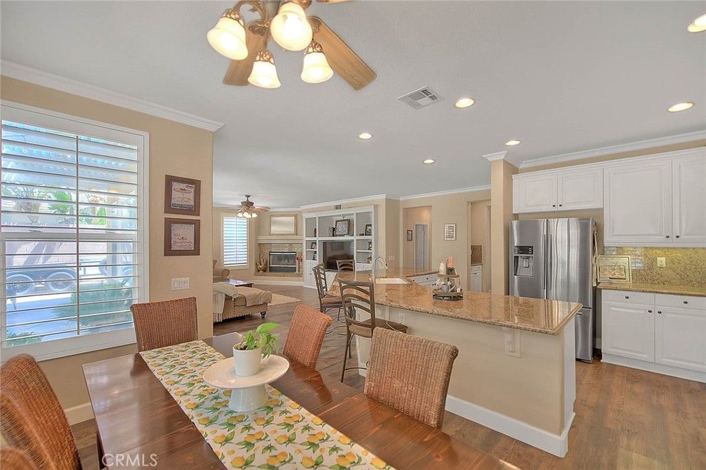 Dining room, Fireplace, Interior, Kitchen, Living room, Recessed Lighting, Stainless Steel Appliances, Wood Texture Flooring