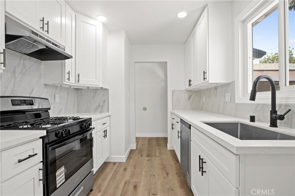 Interior, Kitchen, Marble Walls, Recessed Lighting, Stainless Steel Appliances, Wood Texture Flooring