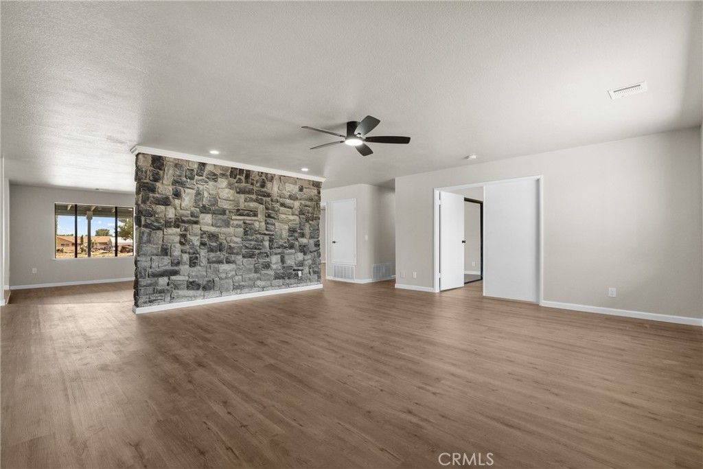 Empty room, Fireplace, Interior, Recessed Lighting, Stone Walls, Wood Texture Flooring