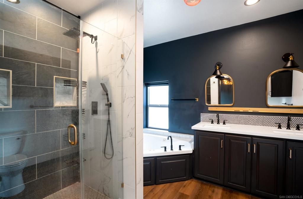 Bathroom, Dual Sink Vanities, Glass Shower, Interior, Marble Walls, Recessed Lighting, Wood Texture Flooring