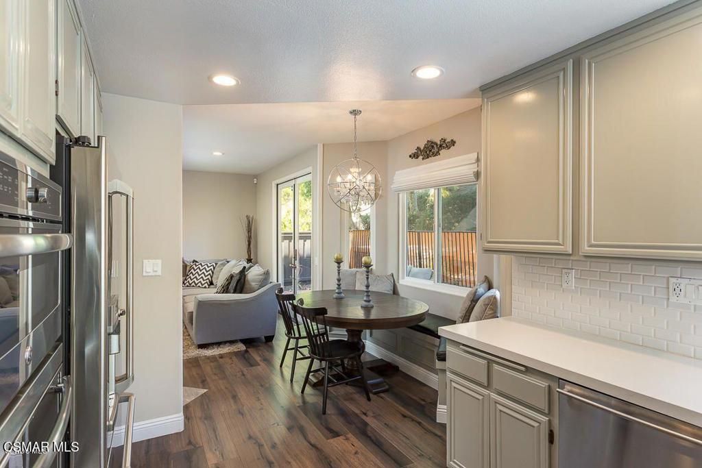 Chandelier, Dining room, Interior, Kitchen, Living room, Pendant Lights, Recessed Lighting, Stainless Steel Appliances, Wood Texture Flooring
